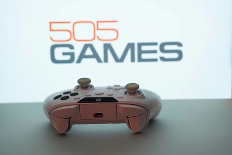 Dhaka, Bangladesh- 23 Sep 2025: Game controller in front of 505 Games logo on a background