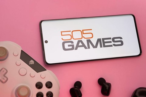 Dhaka, Bangladesh- 23 Sep 2025: Smartphone with 505 Games logo, game controller, and earbuds on a