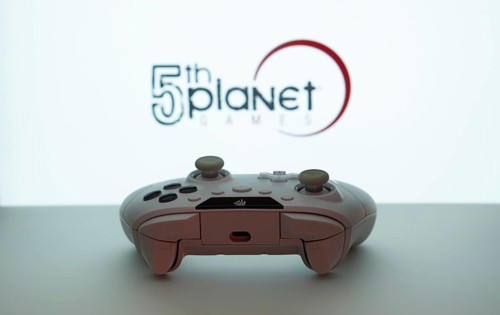 Dhaka, Bangladesh- 23 Sep 2025: Game controller in front of 5th planet games logo on a blue