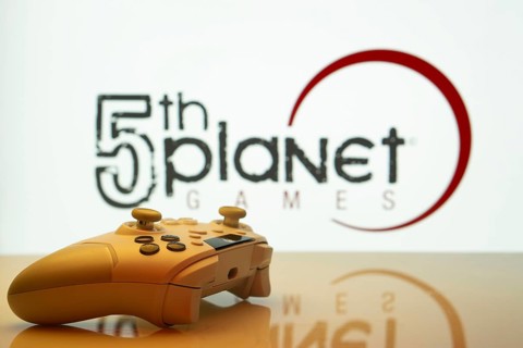Dhaka, Bangladesh- 23 Sep 2025: Game controller in front of 5th planet games logo on a background