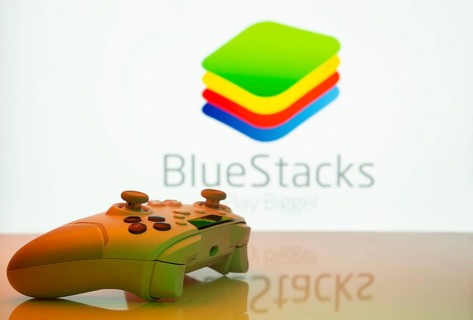 Dhaka, Bangladesh- 23 Sep 2025: Game controller in front of BlueStacks logo on a background