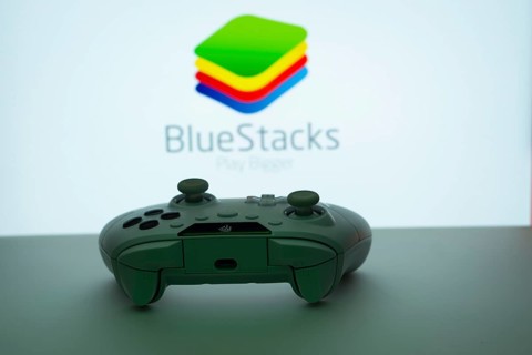 Dhaka, Bangladesh- 23 Sep 2025: Game controller in front of BlueStacks logo on a background