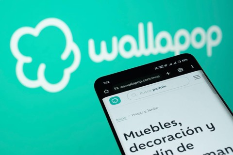 Dhaka, Bangladesh- 03 July 2025: Smartphone displaying Wallapop web interface against wallapop logo