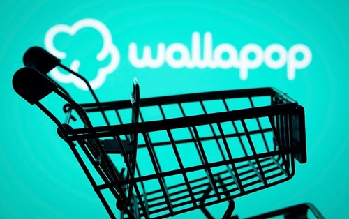 Dhaka, Bangladesh- 03 July 2025: Silhouette of a shopping cart in front of the Wallapop logo,