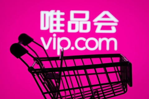 Dhaka, Bangladesh- 03 July 2025: Silhouette of a shopping cart in front of the Vip.com logo,