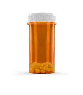 Blank prescription medicine bottle and pills isolated on a white background