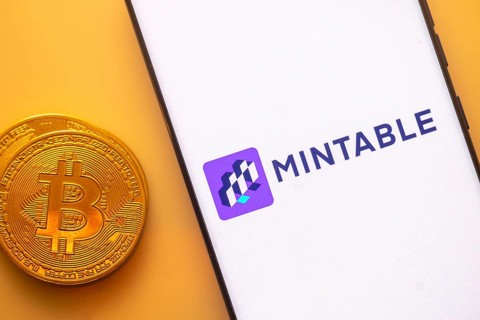 A Bitcoin and Mintable logo on a white screen with a purple square