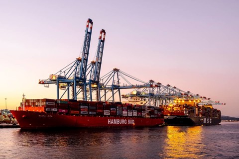 Gibraltar, UK - December 26, 2023: Container ship in the port during sunset