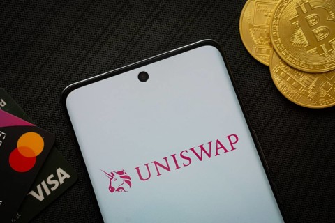 Dhaka, Bangladesh- 19 Sep 2025: Smartphone displaying Uniswap logo surrounded by Bitcoin coins and