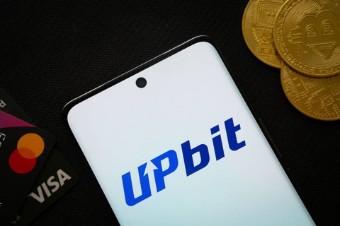 Dhaka, Bangladesh- 19 Sep 2025: Smartphone displaying Upbit logo surrounded by Bitcoin coins and