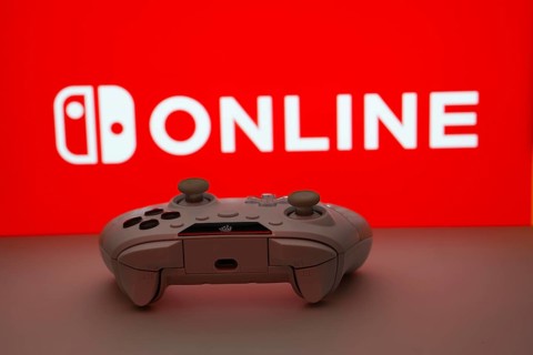 Dhaka, Bangladesh- 15 July 2025: Game controller in front of nintendo online logo on a background