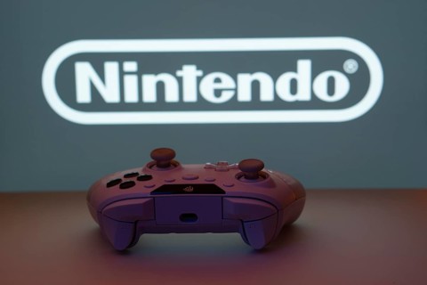 Dhaka, Bangladesh- 15 July 2025: A close-up of a gamepad with the nintendo seen on screen in the