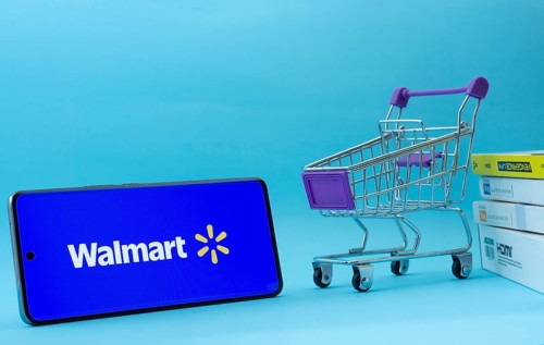 Dhaka, Bangladesh- 03 July 2025: Smartphone with Walmart logo next to a small shopping cart and