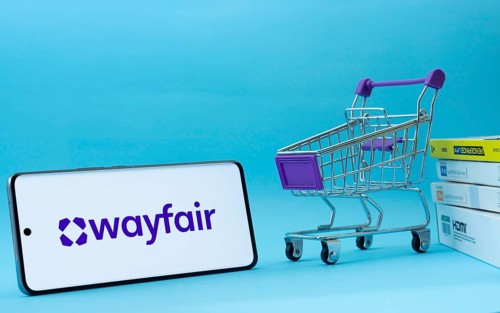 Dhaka, Bangladesh- 03 July 2025: Smartphone with Wayfair logo next to a small shopping cart and