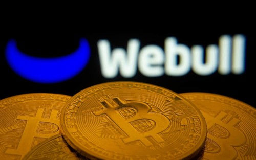Dhaka, Bangladesh- 27 July 2025: Close-up of Bitcoin coins with the webull logo visible on a screen