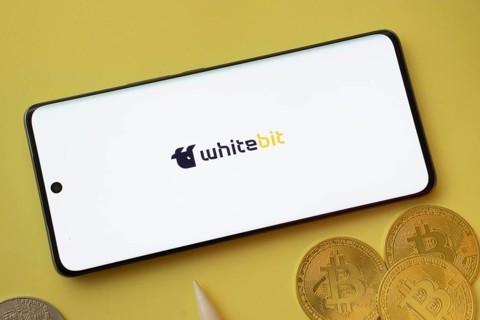 Dhaka, Bangladesh- 03 June 2025: whitebit logo on smartphone screen near Bitcoin coin and QR code