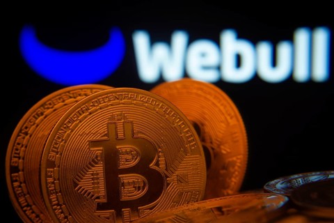 Dhaka, Bangladesh- 03 Sep 2025: Close-up of Bitcoin coins with the webull logo visible on a screen