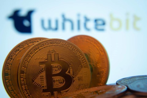 Dhaka, Bangladesh- 03 Sep 2025: Close-up of Bitcoin coins with the whitebit logo visible on a