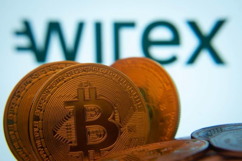 Dhaka, Bangladesh- 02 June 2025: Close-up of Bitcoin coins with the wirex logo visible on a screen