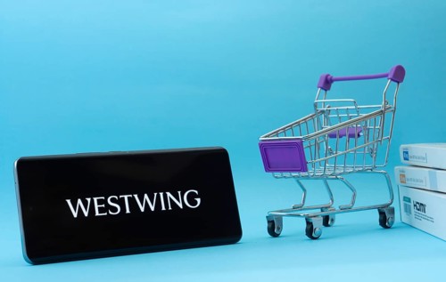 Dhaka, Bangladesh- 03 July 2025: Smartphone with Westwing logo next to a small shopping cart and