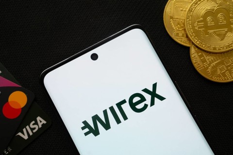 Dhaka, Bangladesh- 15 June 2025: Smartphone displaying wirex logo surrounded by Bitcoin coins and