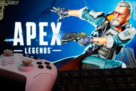 Dhaka, Bangladesh- 19 Sep 2025: A close-up of a white gamepad with the Apex Legends seen on screen