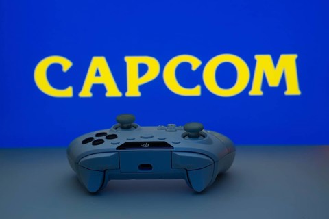 Dhaka, Bangladesh- 19 Sep 2025: A close-up of a white gamepad with the Capcom seen on screen in the