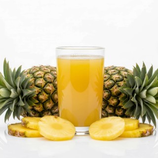 A refreshing glass of pineapple juice is surrounded by whole pineapples and sliced pieces, perfect