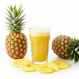 A vibrant image showcasing a glass of freshly squeezed pineapple juice alongside whole pineapples
