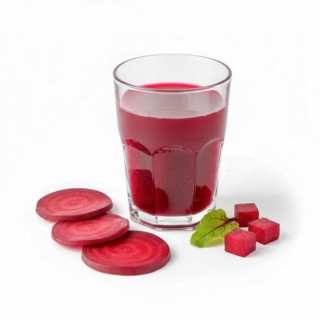 A refreshing glass of vibrant beetroot juice is presented alongside sliced beets and small cubes,