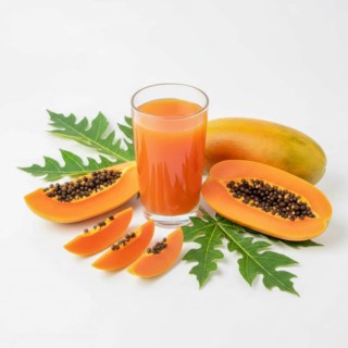 A refreshing glass of papaya juice is presented alongside sliced papaya fruit and vibrant green