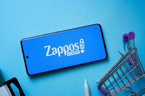 Dhaka, Bangladesh- 03 July 2025: Smartphone displaying Zappos logo with shopping cart on a blue