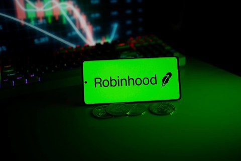 Robinhood logo on a phone with coins, set against a stock chart with green neon glow
