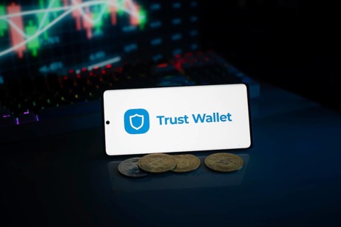 Trust Wallet display with coins against a stock chart backdrop in neon lighting