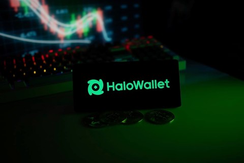 HaloWallet logo highlighted with coins and colorful trading charts in a modern trading ambiance