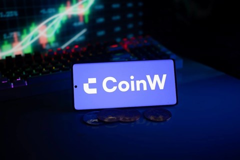 CoinW screen with coins, set in front of a neon-illuminated stock chart in blue