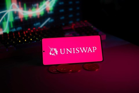 Uniswap logo on smartphone with coins and stock chart, highlighting digital finance and trading