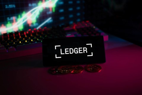 LEDGER logo with coins and trading charts, highlighted by neon-illuminated background