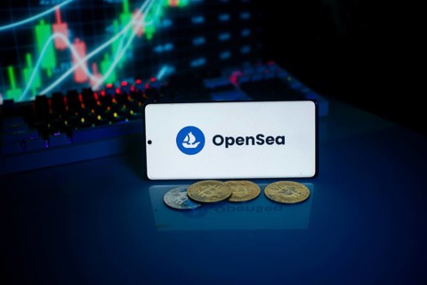 OpenSea logo on phone with coins and market chart, related to NFT and cryptocurrency
