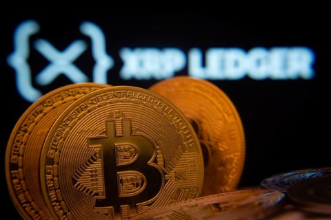 Dhaka, Bangladesh- 03 Sep 2025: Close-up of Bitcoin coins with the XRP Ledger logo visible on a