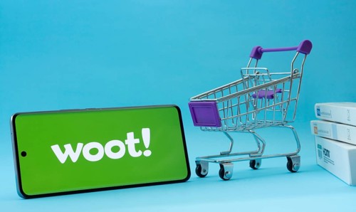 Dhaka, Bangladesh- 03 July 2025: Smartphone with Woot logo next to a small shopping cart and boxes