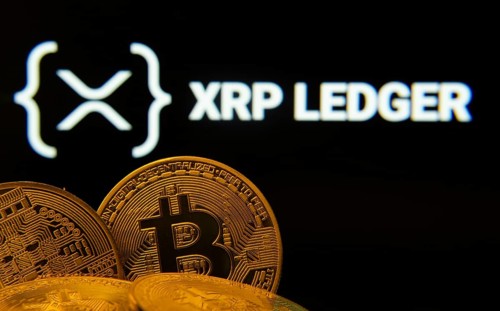 Dhaka, Bangladesh- 27 July 2025: Close-up of Bitcoin coins with the XRP Ledger logo visible on a
