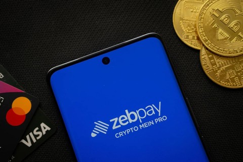 Dhaka, Bangladesh- 15 June 2025: Smartphone displaying zebpay logo surrounded by Bitcoin coins and