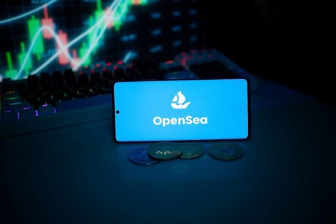 OpenSea on a smartphone with coins and market data on a screen