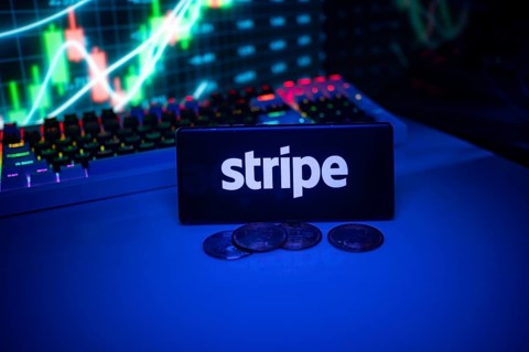Stripe shown on a smartphone surrounded by coins and trading visuals