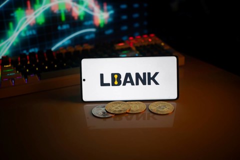 Phone displays LBank logo with crypto coins and trading screen in background