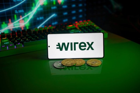Phone displays Wirex logo with crypto coins and trading screen in background