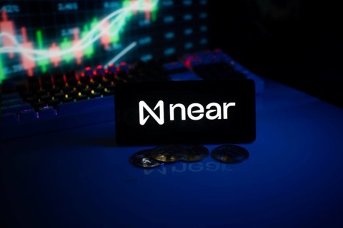 Near app on smartphone screen with coins and stock graph displayed behind
