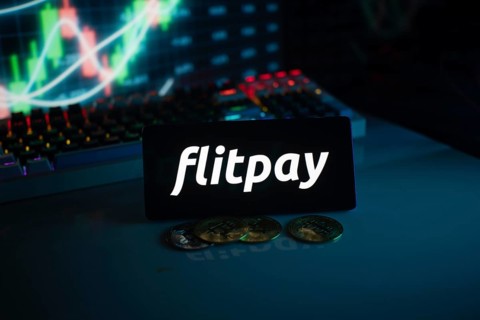 Flitpay logo in a dark setting with coins and a glowing financial chart
