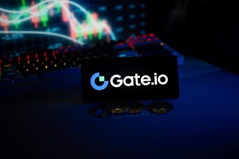 Gate.io logo displayed on a phone with cryptocurrency coins and market charts